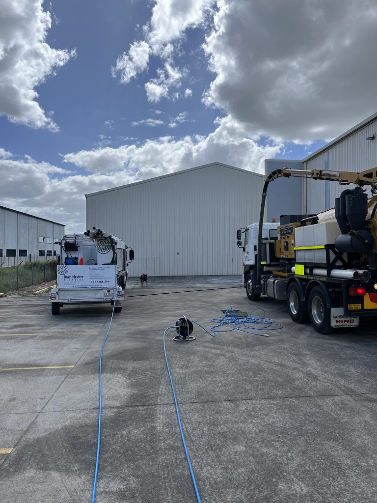 Hydro-excavation team working with Drain Masters to clear a commercial stormwater system packed with bolts, nuts, rust and oils.