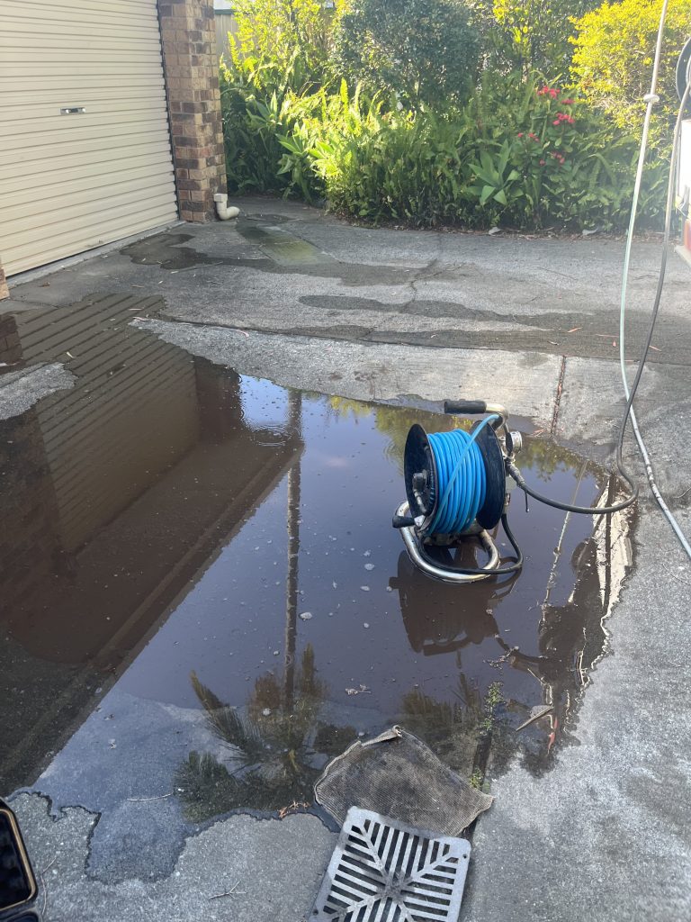 Replacement river-rock overflow area where a failed rubble pit used to discharge stormwater at a Kingscliff property.