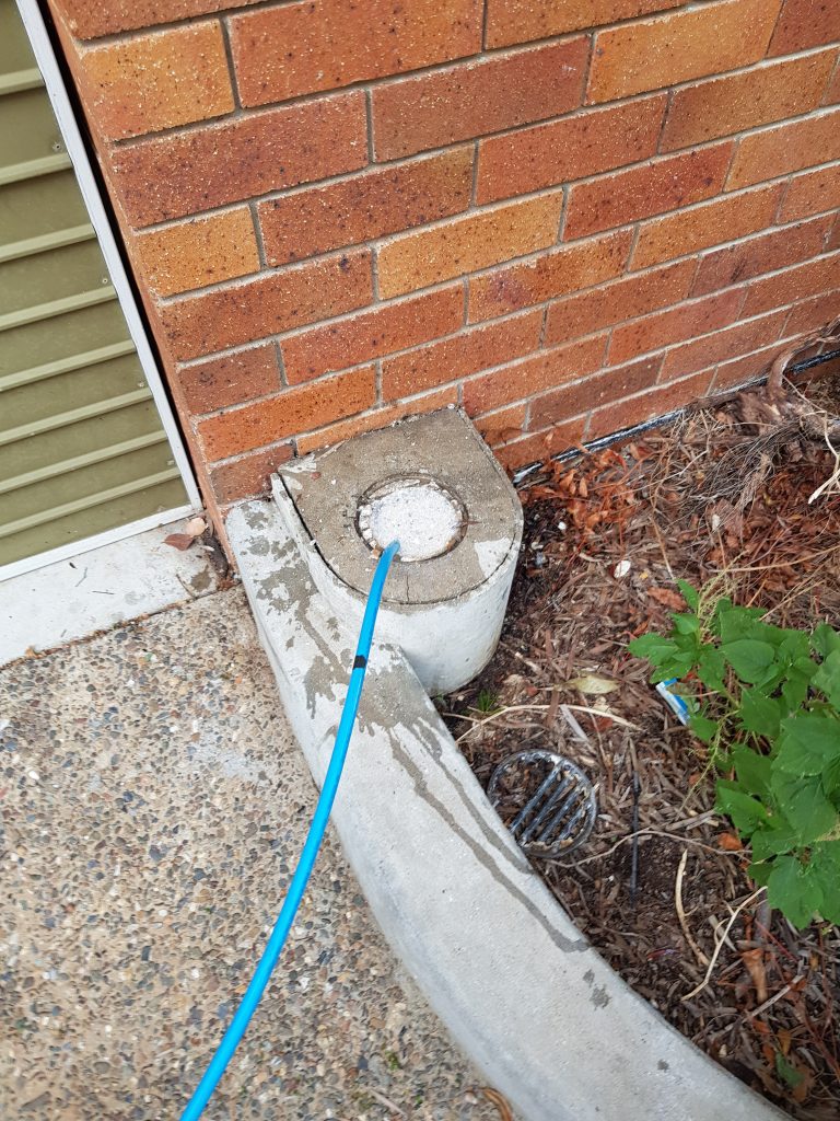 Blocked drain cleared from inside a unit complex bathroom after removing the toilet for machine access.